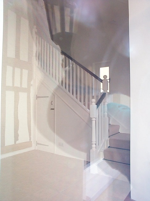 White painted stairs with turned newels and hardwood handrail