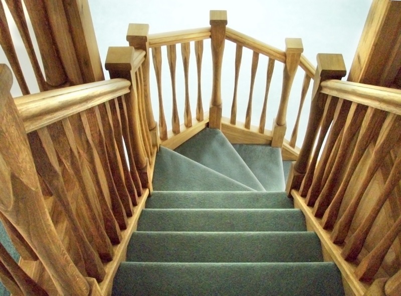 Oak staircase with slender style spindles and newels. Left wind.