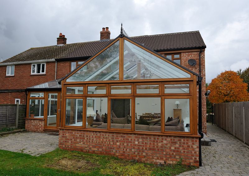 Stained hardwood Conservatory with automatic roof lights.