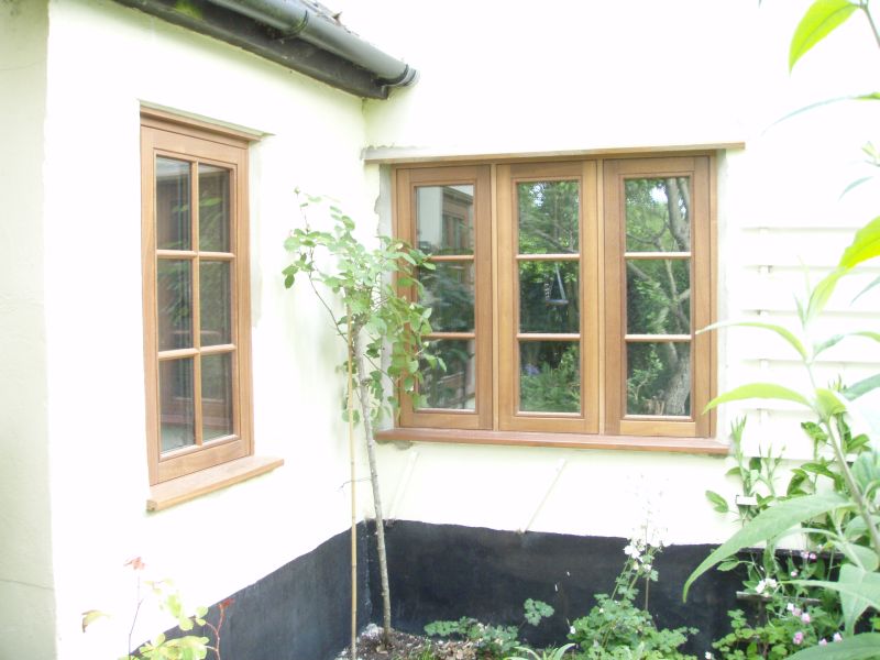 Single and triple casement stained timber windows with double horizontal bars